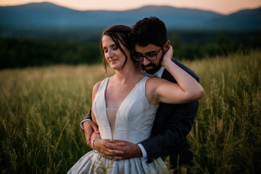 A couple embraces during sunset after their Grace Estate Winery wedding.