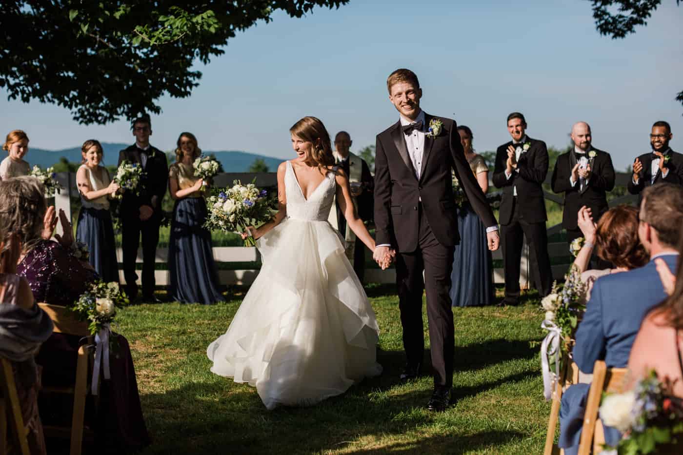 A couple walks down the aisle after their wedding at James Monroe's Highland