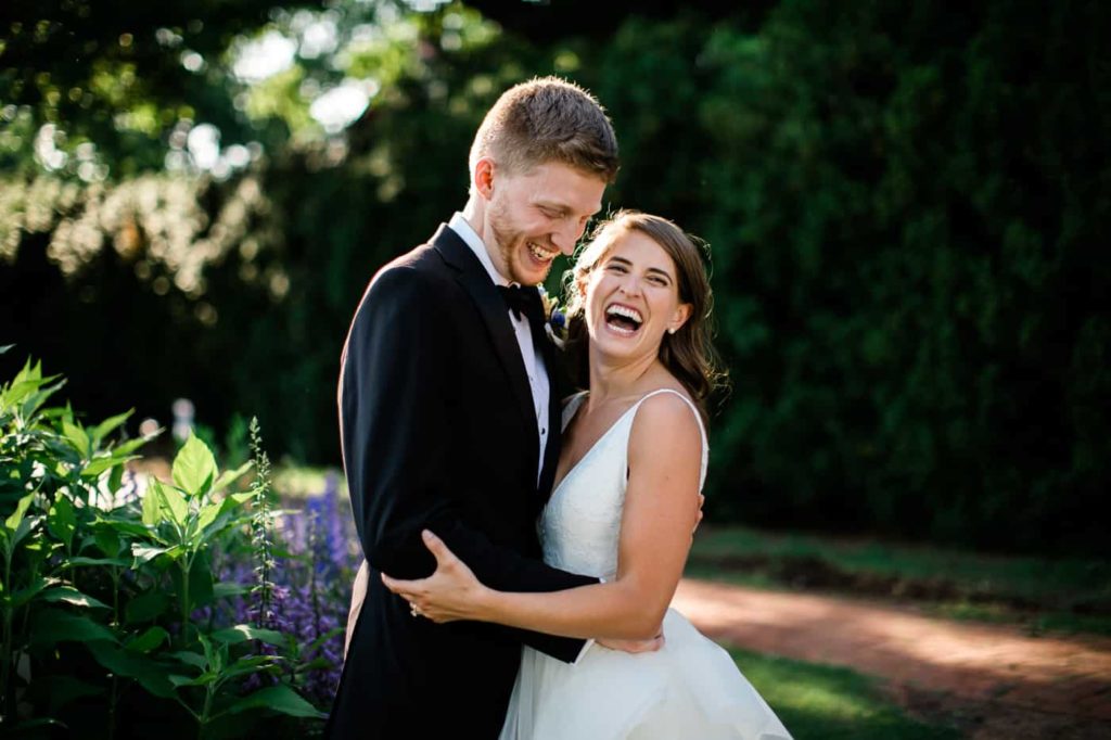 A couple laughs in the gardens at James Monroe's Highland -- a garden wedding venue outside of Charlottesville 