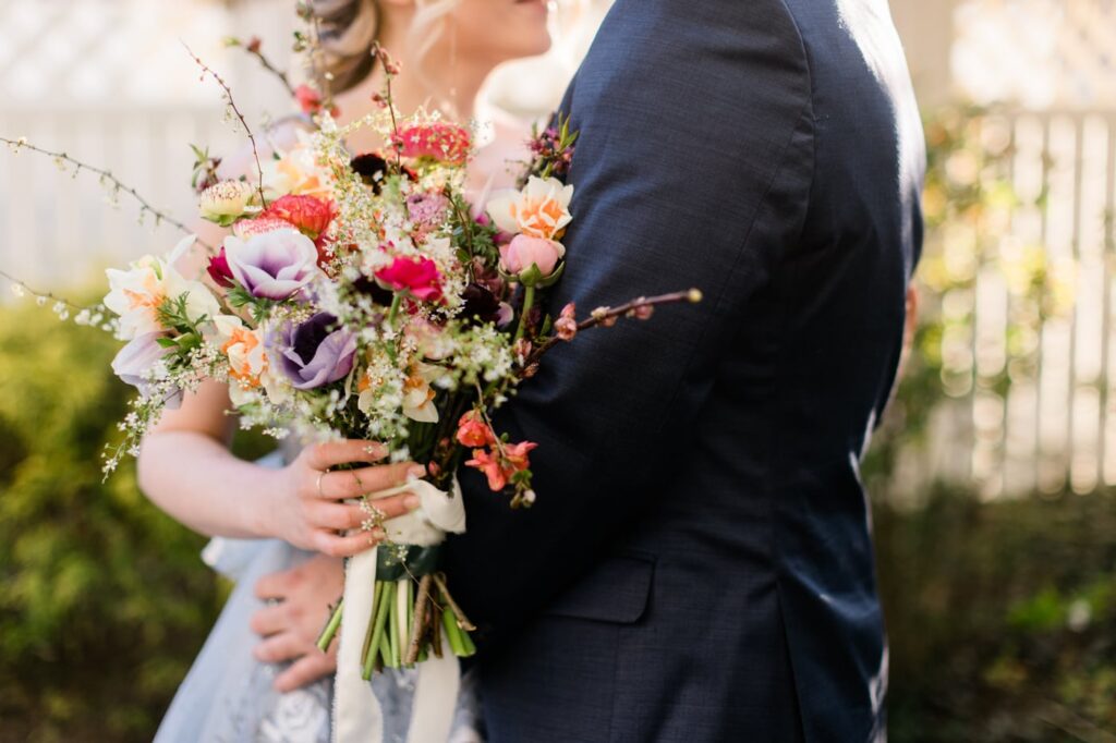 A bride holds a spring bouquet during a romantic garden wedding editorial shoot in Roanoke