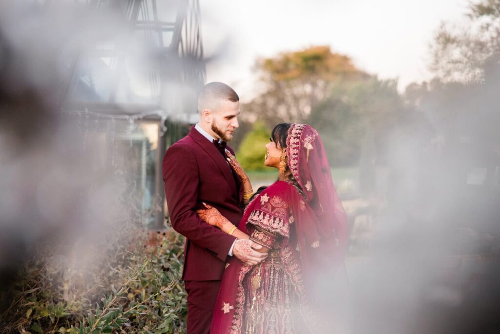 A wedding couple hug during the portrait section of an Indian-American wedding at Meadowlark Botanical Gardens