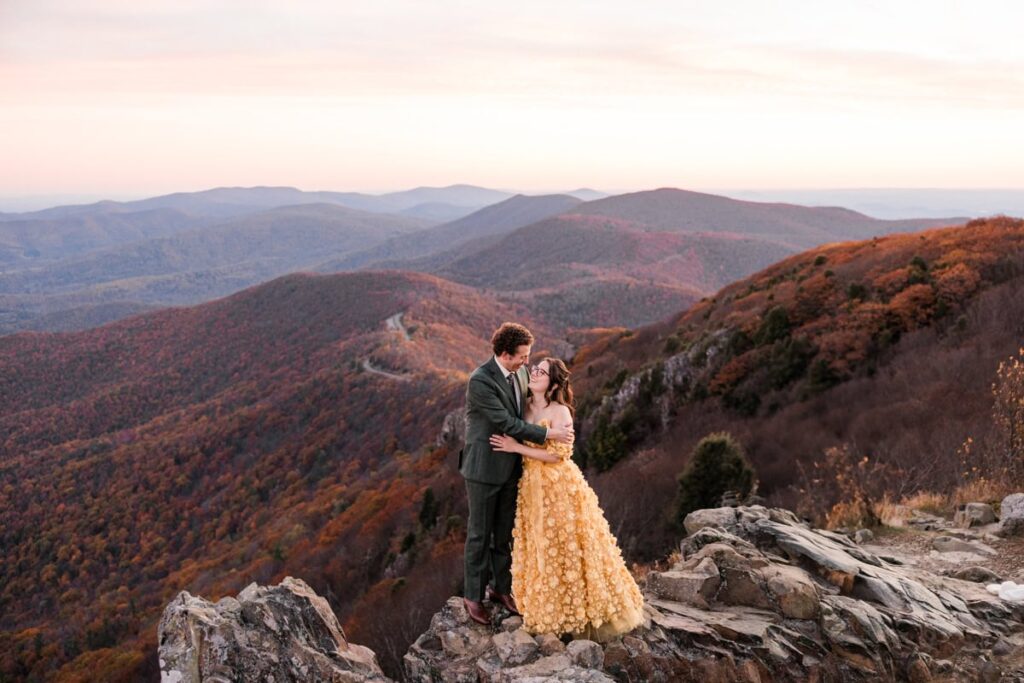 A woman wears a yellow wedding dress for her Shenandoah National Park adventure elopement